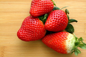 Strawberries on bamboo background