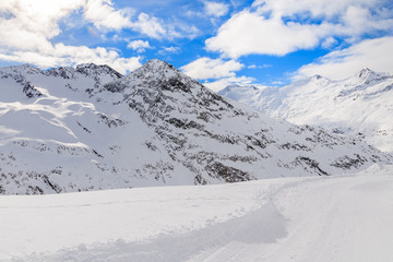 Fototapeta na wymiar Groomed walking track in beautiful mountains during winter season, Obergurgl-Hochgurgl ski area, Austria