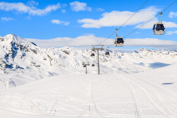 Fototapeta na wymiar Gondola cars on lift in mountains in winter season in Hochgurgl-Obergurgl ski area, Tirol, Austria