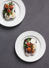 Danish open sandwich smorrebrod with herring, onion and eggs. Top view.