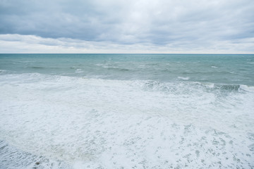 Fototapeta premium View of storm seascape. Grey clouds, sea foam