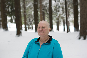 Cancer patient with bald head in woods