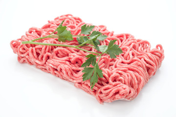block of minced meat with parsley, isolated on white background