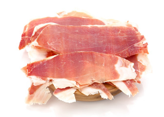 Spanish serrano ham on wooden board, isolated on white background