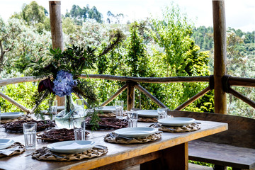 Table set in an outside hut with beatiful views to the forest