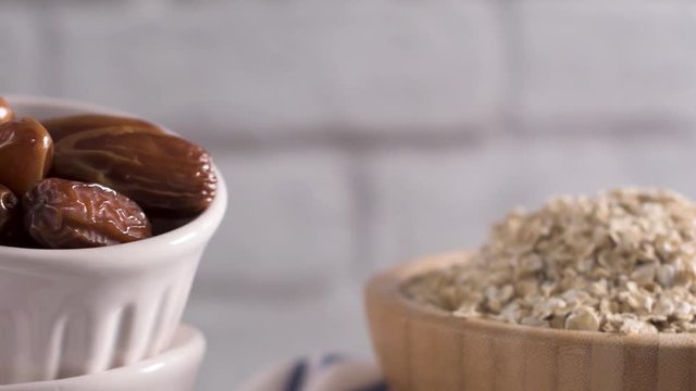 Homemade energy balls ingredients, date fruits and oat flakes.