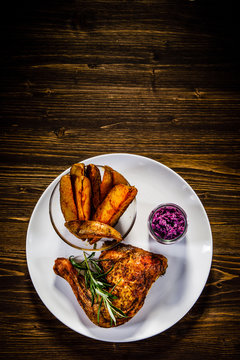 Roast chicken legs with chips and vegetables