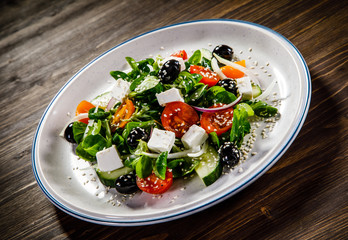 Greek salad on wooden background