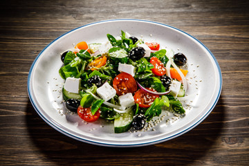 Greek salad on wooden background