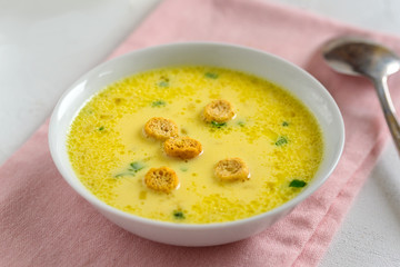Cheese soup with croutons and fresh herbs.