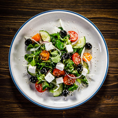 Greek salad on wooden background