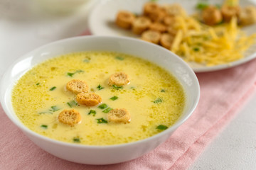Cheese soup with croutons and fresh herbs.