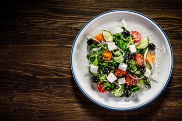Greek salad on wooden background
