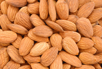 Pile of almonds close-up as background.