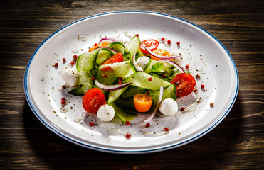 Caprese salad on wooden background