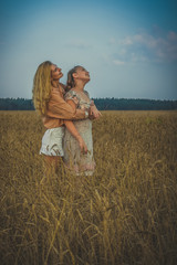 nature, summer holidays, vacation and people concept - happy smiling woman in wreath of flowers lying on straw