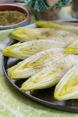 Fresh raw Belgian bitter chicory salad ready to cook