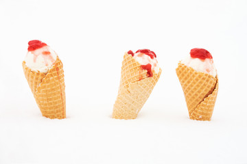 ice cream in waffle cone with red jelly in snow