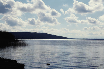 Ammersee Bavarian lake near Munich, panoramic winter view, coastline and sky reflecting on the water surface with a luminous stripe at the horizon