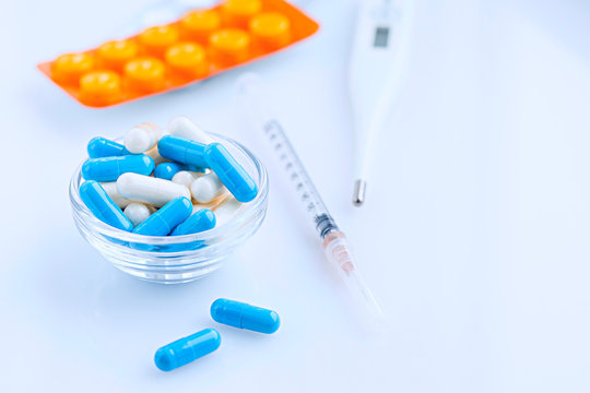 Pharmaceutical pills, tablets and capsules. Blue and white medicine capsules closeup
