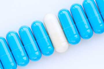 Pharmaceutical medicine capsules. Blue and white medicine capsules. Top view of medicine capsules