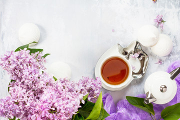 Relaxation time concept. Homemade zephyr with cup of tea on a cozy kitchen table. Copy space, top view flat lay background.