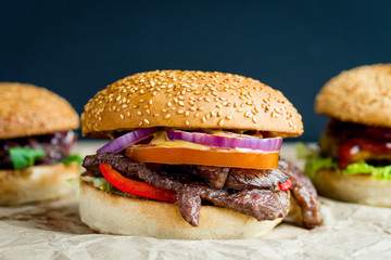 Beef burger with tomato, salad and cheese