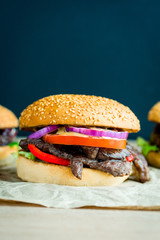 Beef burger with tomato, salad and cheese