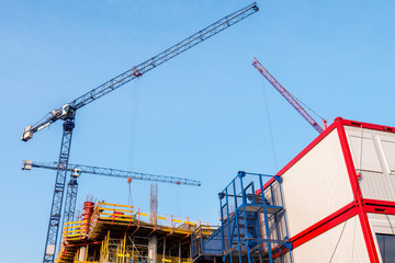 Large construction, cranes working on a building complex
