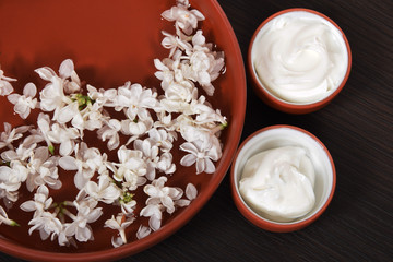natural face cream from jasmin and lilac for wrinkles in plastic containers with elder flowers
