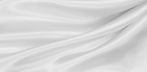Fototapeta na wymiar Smooth elegant white silk or satin luxury cloth texture as wedding background. Luxurious Christmas background or New Year background design