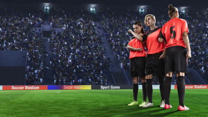 three female soccer players making wall before penalty shot