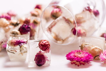 Fototapeta na wymiar Frozen flowers, ice cubes floristic decoration