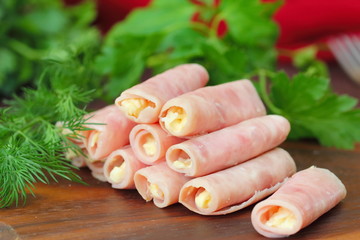 Rolls made of ham stuffed with cheese, garlic and mayonnaise