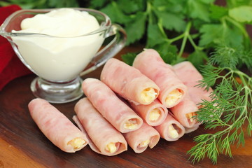 Rolls made of ham stuffed with cheese, garlic and mayonnaise