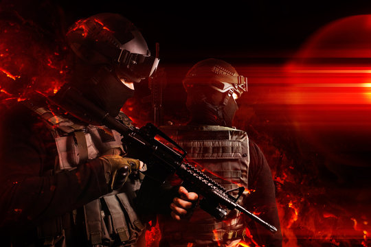 Photo of a swat soldiers posing with automatic rifle in flame effects.