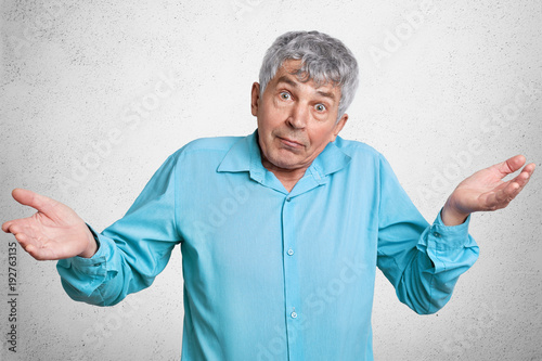 Elderly Puzzled Male With Grey Hair Feels Uncertain About