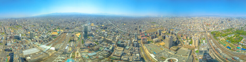 Fototapeta premium Panorama background of Osaka skyline from observation deck of Osaka's Abeno Harukas, the tallest skyscraper in Japan. Aerial view of Kintetsu Osaka Abenobashi Station and JR Tennoji Station.Copy space