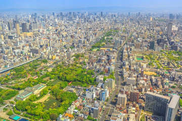Obraz premium Panoramic aerial view of Tennoji zoo and Osaka cityscape from at viewing platform of a top of Osaka's Abeno Harukas, the tallest skyscraper in Japan. Sunny day.