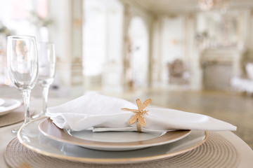 Close-up layout of the festive table. decorated table and chairs for a festive dinner. Luxury decor with daylight. modern photographic studio. Light spring room studio interior.