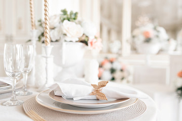 Close-up layout of the festive table. decorated table and chairs for a festive dinner. Luxury decor with daylight. modern photographic studio. Light spring room studio interior.