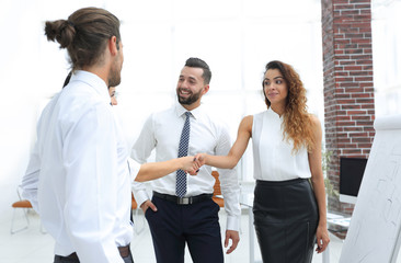 business women greet each other with a handshake