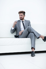 Portrait of a businessman in a suit with a cigarette