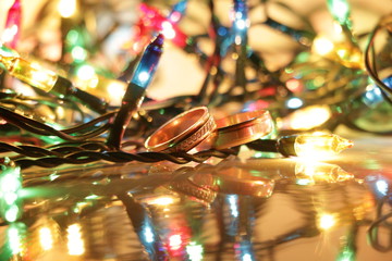 Wedding rings on the background of Christmas lights