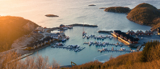 Top view of the harbour with moored yachts and boats  in the village of Tonnes at sunset. © Елена Нестерова