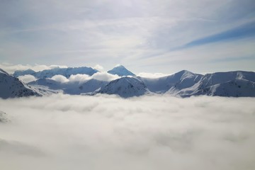 Mountain peaks over clouds