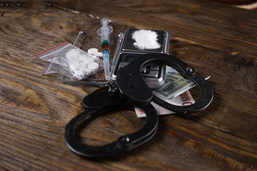 Illegal drugs, money and handcuffs