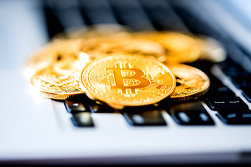 Bitcoin coins on a computer keyboard as a symbol of electronic money.