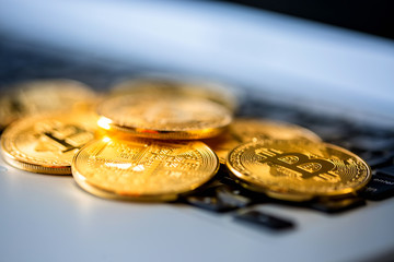 Bitcoin coins on a computer keyboard as a symbol of electronic money.