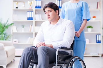 Disabled patient on wheelchair visiting doctor for regular check